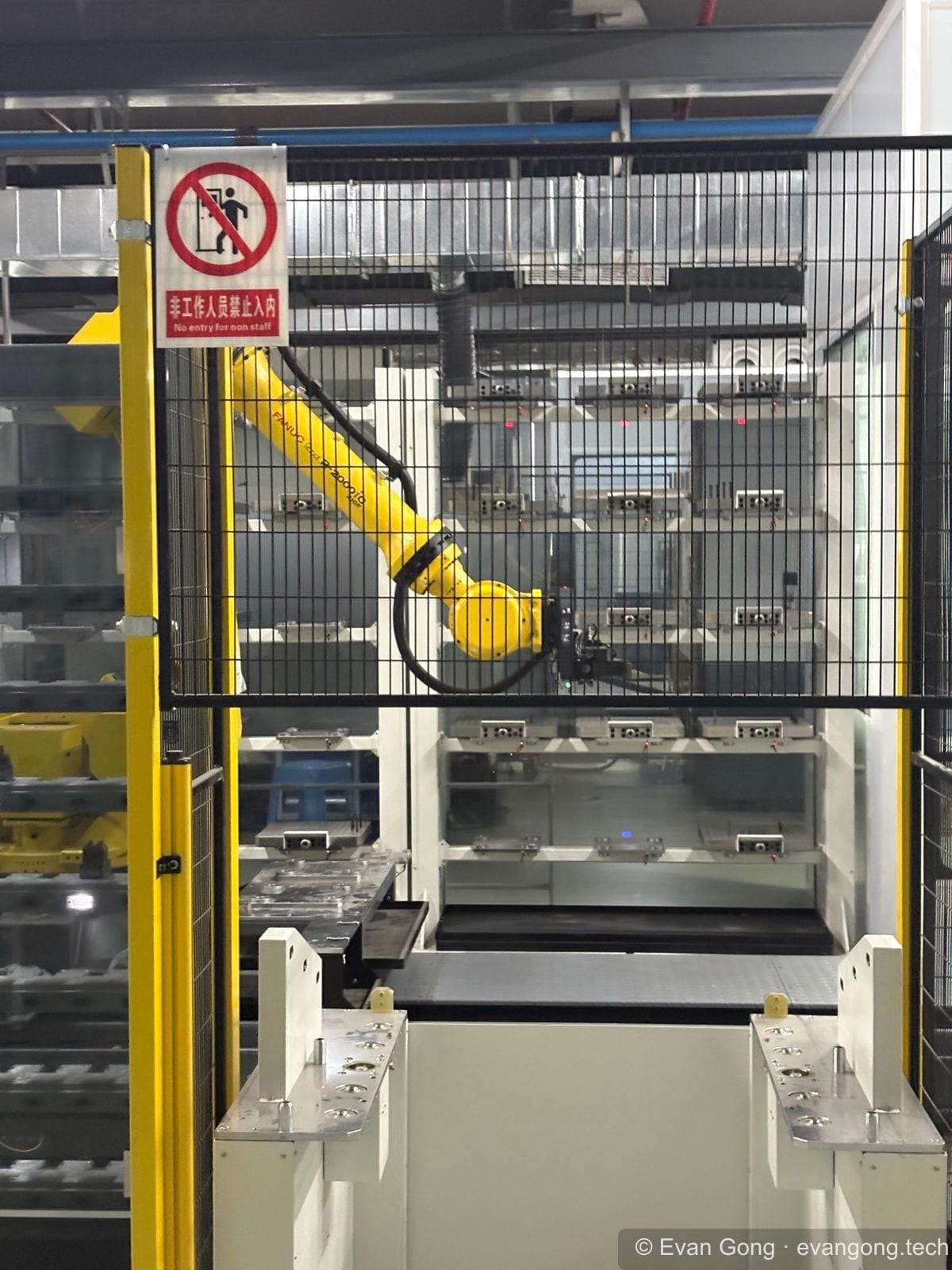 Industrial robotic arm inside a guarded manufacturing cell at Shenzhen InnoX Academy